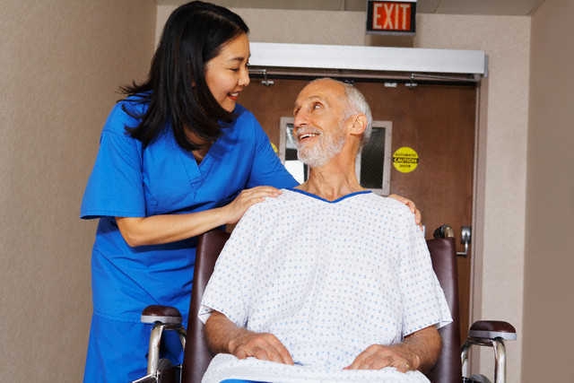 Nurse with Senior Man in Wheelchair --- Image by © Artiga Photo/Corbis