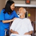 Nurse with Senior Man in Wheelchair --- Image by © Artiga Photo/Corbis